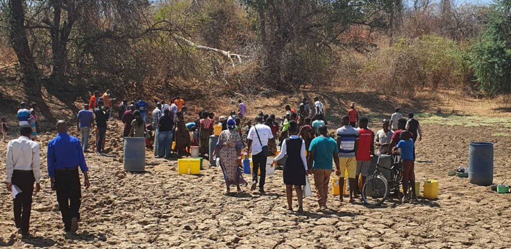 People standing in line to collect water in an area of the Kafue Flats affected by drought. Credit WWF.