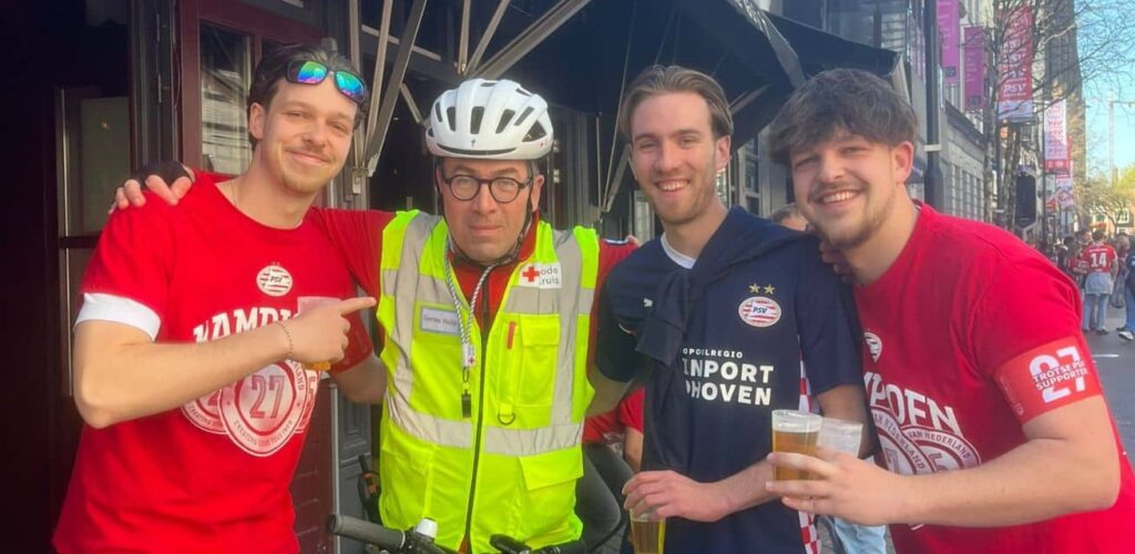 Rode Kruis-vrijwilliger Stefan met zijn zoon op de huldiging van PSV